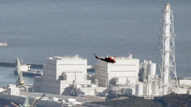 A helicopter flies past Japan's Fukushima Daiichi No.1 Nuclear reactor in March, 2011. 