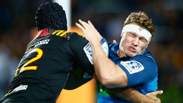 Tight clash: Blake Gibson of the Blues is tacked by Charlie Ngatai of the Chiefs.