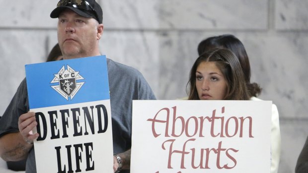 Demonstrators rally at Utah Capitol Rotunda, in Salt Lake City, in August, to support the move decision to remove the state from federal funding of Planned Parenthood. 