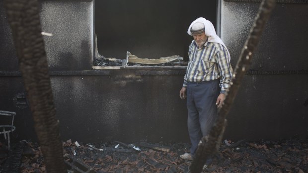 Relatives of the Dawabsheh family inspect the remains of the  house after a fire which was suspected to have been set by Jewish extremists in July. 