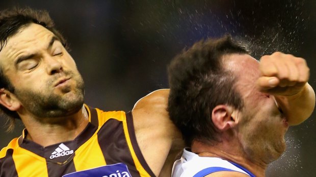 Hawk Jordan Lewis collects Todd Goldstein in the head as he attempts to spoil during the round five match against North Melbourne.