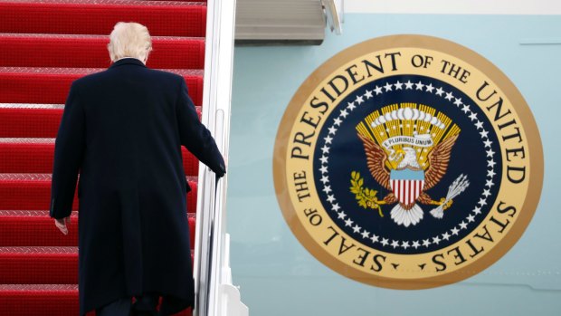 US President Donald Trump walks up the steps of Air Force One.