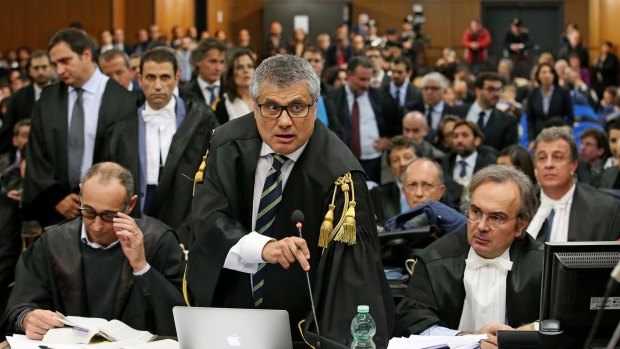 Prosecutors Giuseppe Cascini, left, Paolo Ielo, centre, and Luca Tescaroli attend the first hearing of the trial of involving politicians and businessmen.