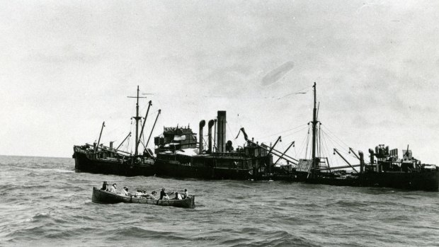 <i>Macumba</i> sinking with one of the lifeboats in the foreground. 
