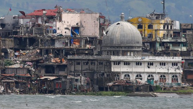 Another crisis: a mosque with its dome blasted out with holes is seen at the battle-scarred Marawi city in southern Philippines.