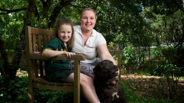 Breast cancer sufferer Melanie Cage relaxes at her home in Lawson with her daughter Shaylee and dog Max.
