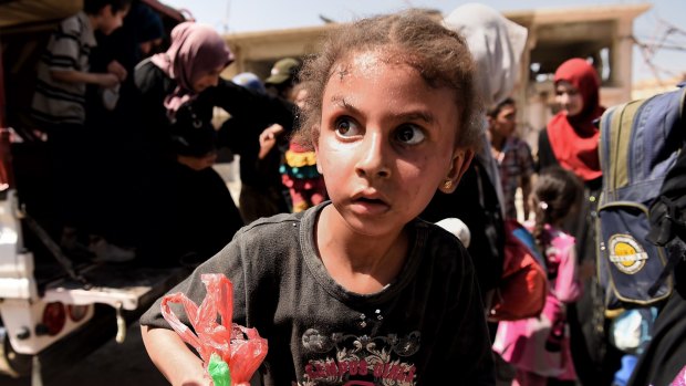 A girl in state of shock arrives with her family at a screening point in western Mosul after being rescued by Iraqi forces.