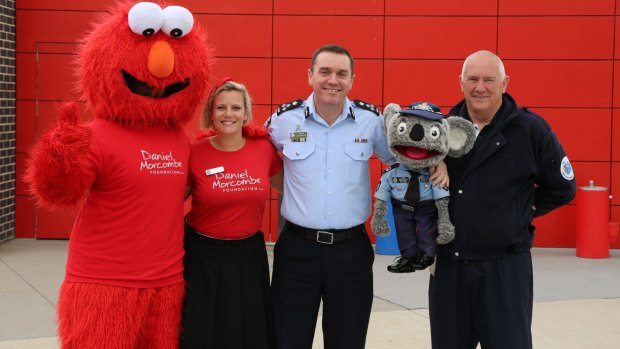 Elmo, AFP's cyber and child safety team leader Rosie Garland, acting Assistant Commissioner Chris Sheehan, Constable Kenny and Stewart Waters during A Day For Daniel at Mother Teresa Primary School in Harrison.