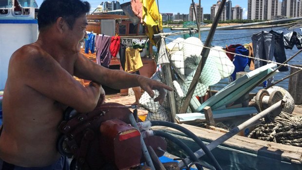 Huang, 47, lives with his family in their fishing boat, near where a new South China Sea museum is being built in Tanmen.