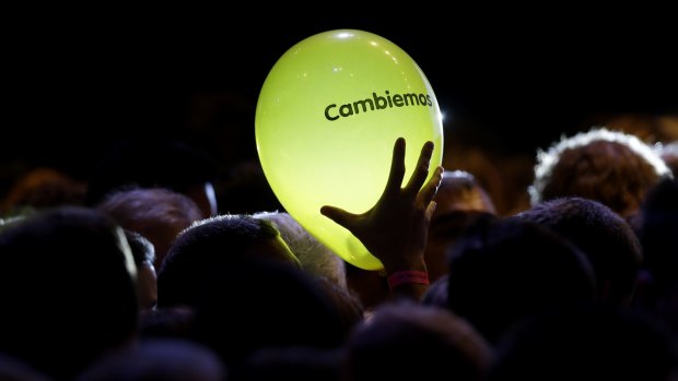 Let's change: A supporter of opposition presidential candidate Mauricio Macri holds a balloon with the logo of the party in Buenos Aires, Argentina, on Sunday.