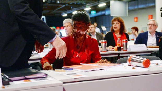 German MP Sahra Wagenknecht has her face covered with cream after activists threw a cake at her during a party congress in Magdeburg, Germany.
