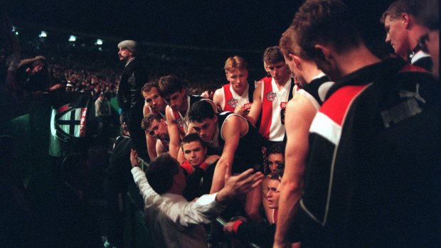 tfz - supplied: Stan Alves talks to players during the blackout at Waverley Park oval when the lights went out at a night football match:  Essendon v St Kilda