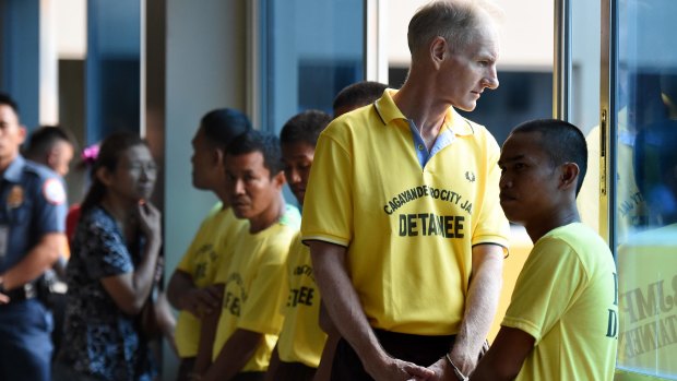 Peter Scully (2nd from right) on his first day of his trial.