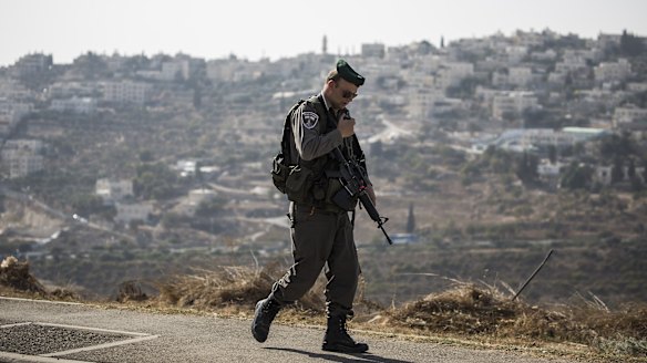 Police guard the site of one of the attempted stabbings on Saturday.
