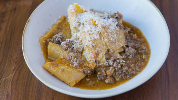 Bolognese clings to thick pappardelle strips.