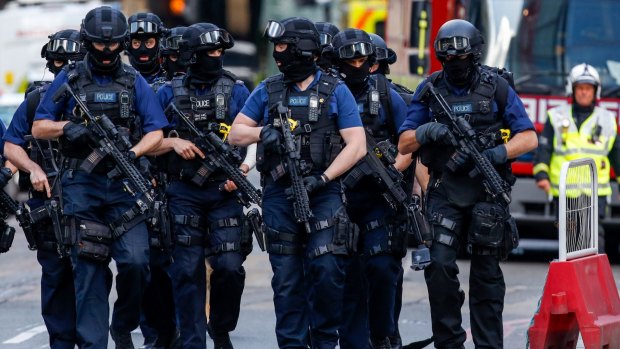 Armed police officers patrol streets near the scene of the terror attack in London.