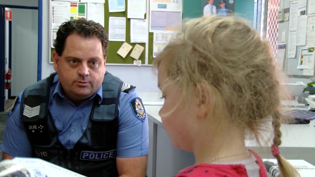 Mundaring Police officer-in-charge, Jeffrey Taylor with young Alison. 
