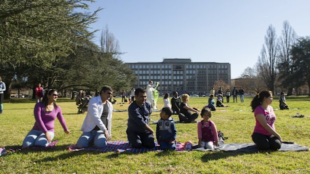 Praksh Penchl and his family participate in an outdoor yoga class to mark the official International Day of Yoga.