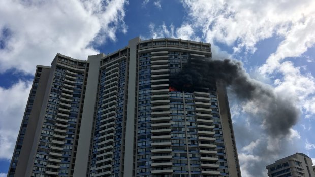 Smoke billows from a high-rise apartment building in Honolulu.
