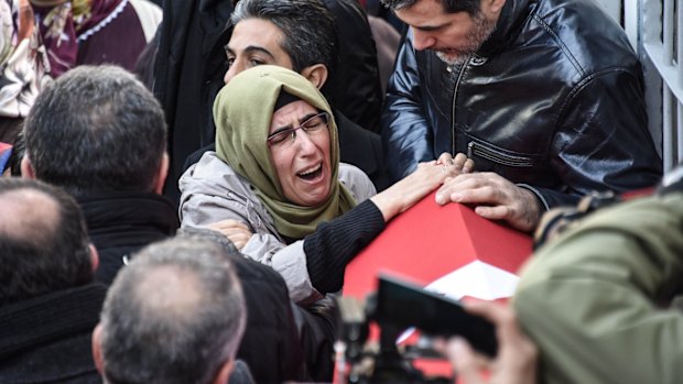 Family and friends of Fatih Cakmak, a security guard killed in the Istanbul nightclub attack, mourn during his funeral on Monday.