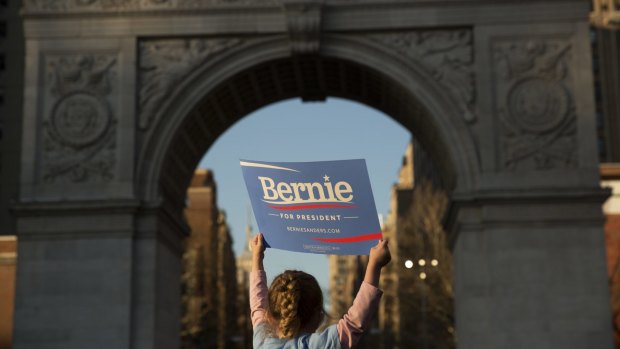 An supporter holds a sign for Senator Bernie Sanders.