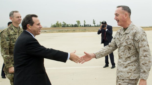 Growing cooperation: US ambassador to Iraq Stuart Jones (in suit) greets General Joseph Dunford, chairman of the US Joint Chiefs of Staff, in Erbil, the capital of Iraq's Kurdish region, on Tuesday.