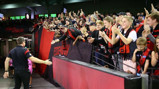 Loss, but no loss of heart: Essendon fans and coach John Worsfold after the North Melbourne game.