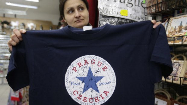 A vendor displays a T-shirt with the word "Czechia" in a store in Prague, Czech Republic.