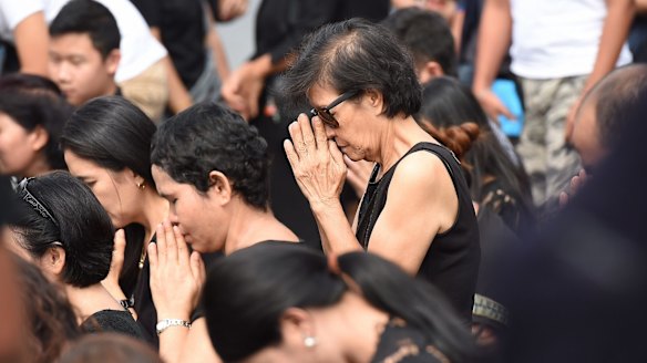 Crowds gather to pray at The Grand Palace following the death of Thailand's King Bhumibol Adulyadej at the age of 88.