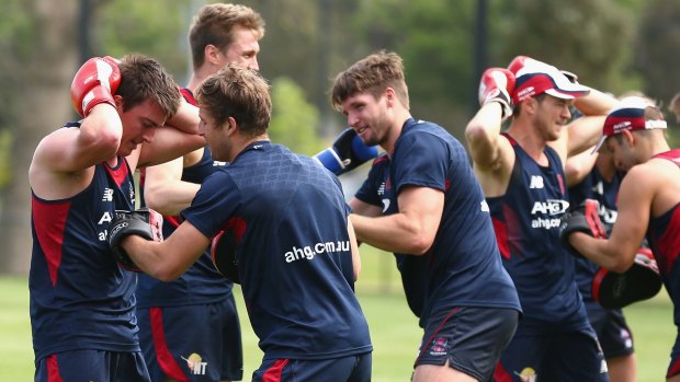 Melbourne players donned gloves during a training session on Wednesday