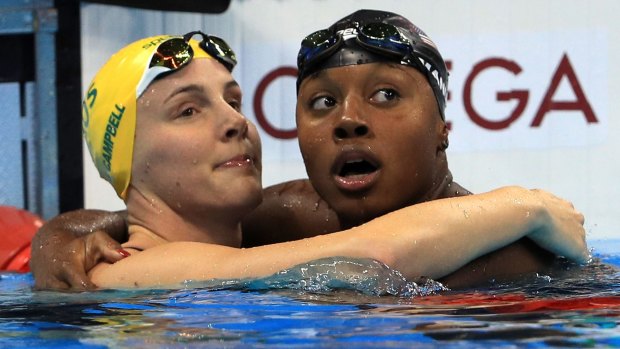 100m joint winner Simone Manuel, right, is congratulated by Bronte Campbell (4th).