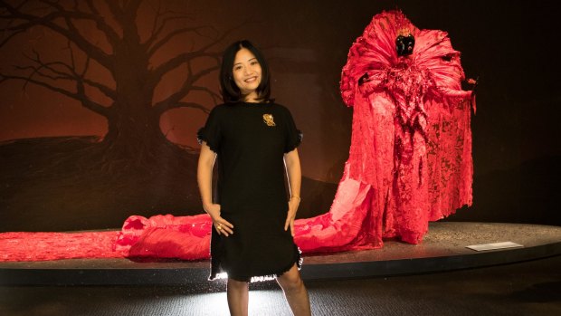 Guo Pei in her "Melbourne" dress next to her works at NGV Triennial.