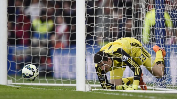 Beaten: Chelsea goalkeeper Thibaut Courtois looks dejected after Charlie Adam scored.