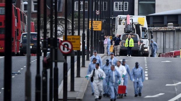 The white van used in the attack is loaded onto a truck on London Bridge in London, England. 