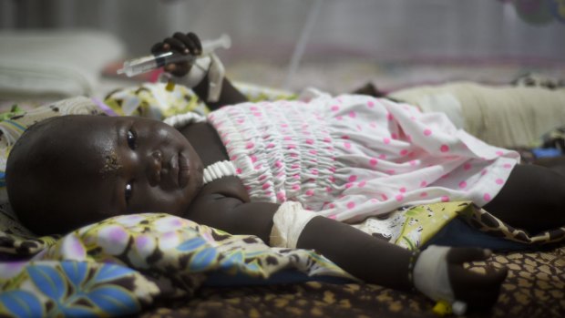 Nyalou Thong, 13 months old and one of only two people who survived Wednesday's cargo plane crash, lies in a hospital bed in Juba.
