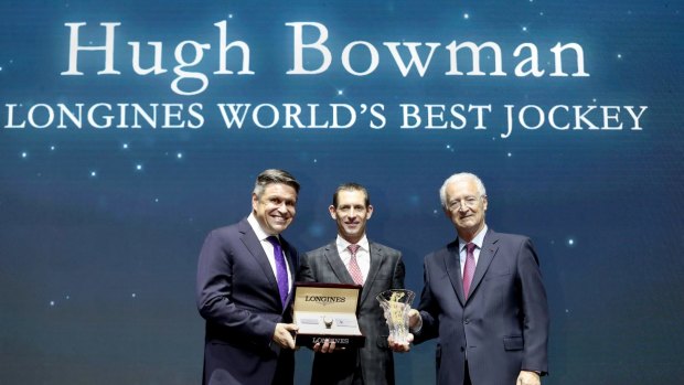 Juan-Carlos Capelli, left, and Louis Romanet, right, present Hugh Bowman with his award.
