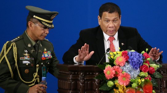 Philippines President Rodrigo Duterte, right, makes a speech during the Philippines-China Trade and Investment Fourm at the Great Hall of the People in Beijing on Thursday.