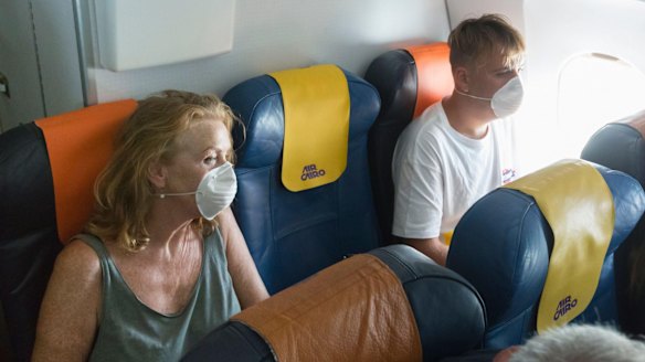 Book the aisle and window seats in the same row, then hope that the middle seat remains empty.