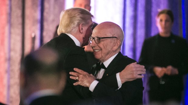 Billionaire bromance: President Trump and Rupert Murdoch embrace at a dinner honouring war veterans in May.