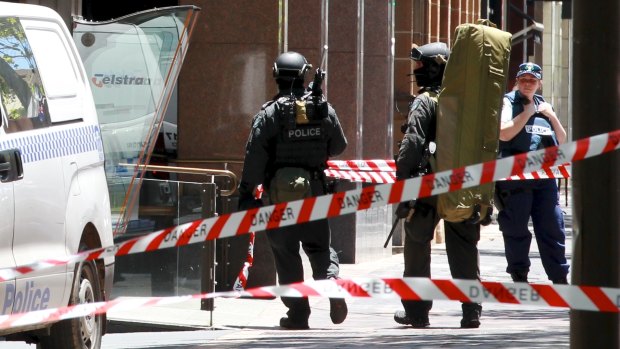 Snipers enter Martin Place from Macquarie Street as the siege unfolded.