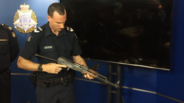 A Victoria Police ballistics officer with a firearm seized this year.