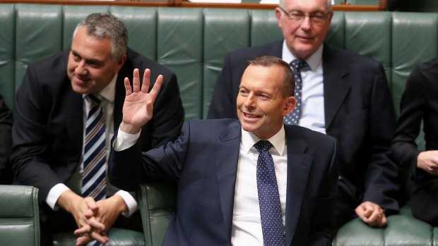 Mr Abbott waves at the public gallery during question time.