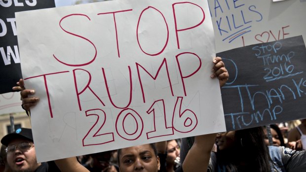 A demonstrator holds a "Stop Trump 2016" sign at West Chester University in West Chester, Pennsylvania.