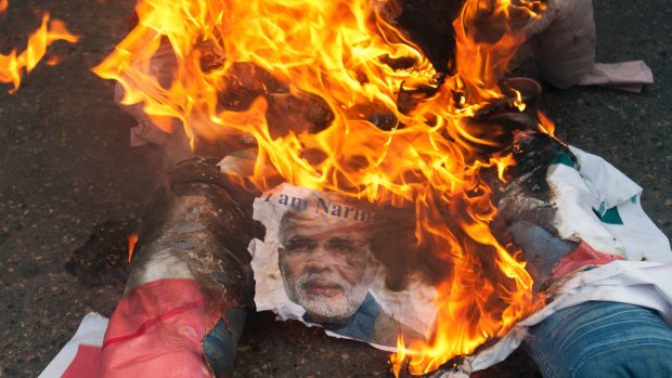 An effigy of Prime Minister Modi burns during a protest rally in Karachi, Pakistan last month. Pakistan's parliament has adopted a resolution condemning India's actions in the disputed region of Kashmir. 