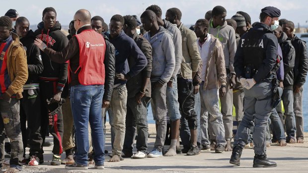 Migrants arrive at the Sicilian harbour of Pozzallo after being rescued by the Italian coast guard on Sunday.