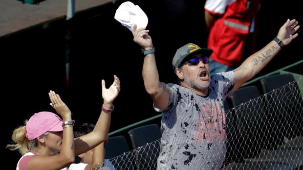 Soccer star Diego Maradona, right, and his girlfriend Rocio Olivia watching the Davis Cup in Buenos Aires.