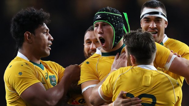 Improver: Adam Coleman celebrates scoring a try against Argentina.