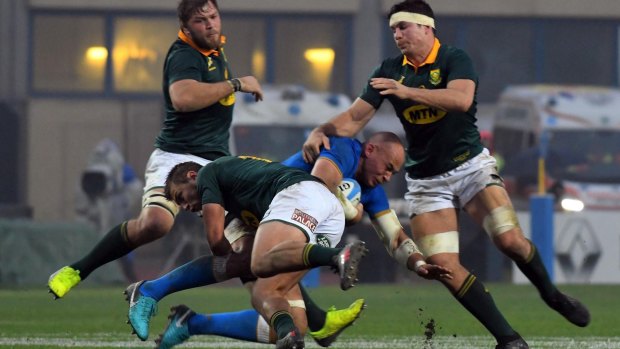 Heavy defence: Italy's Sergio Parisse,  is tackled by the Springboks.