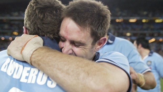 Band back together: Brad Fittler embraces then-NSW captain Danny Buderus after a 2004 victory.