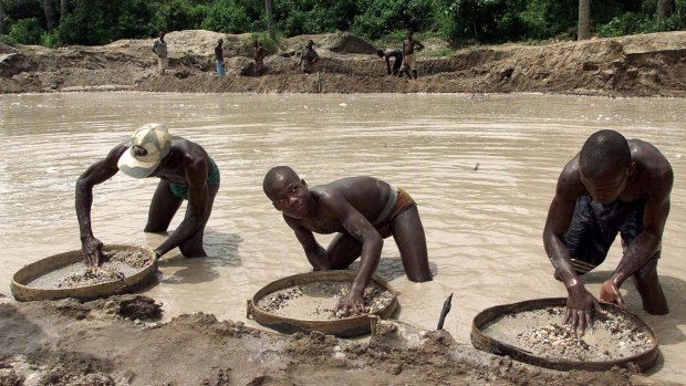 Diamond prospectors sift through the earth in the Corbert mine in Waiima, Sierra Leone. 